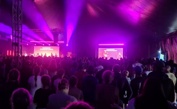 A crowd worshipping in the big top